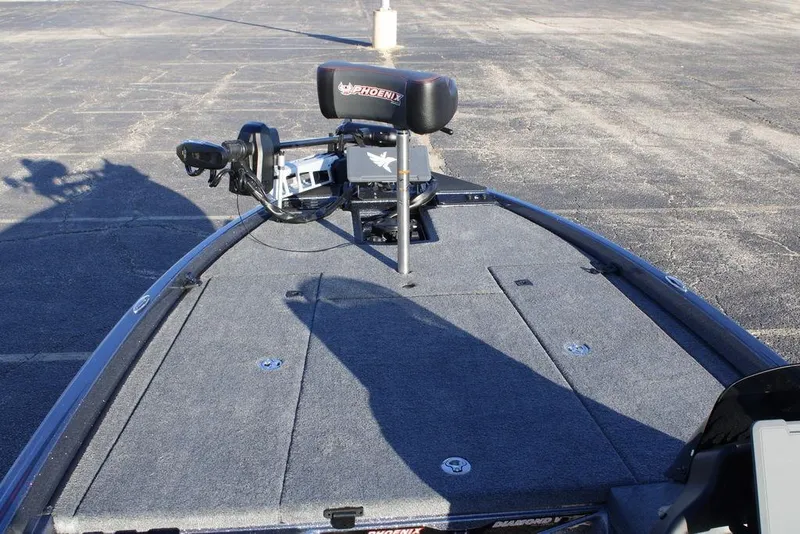 Slide: The Image of 2026 Phoenix 721 boat deck with trolling motor and seating in a parking lot. - 11
