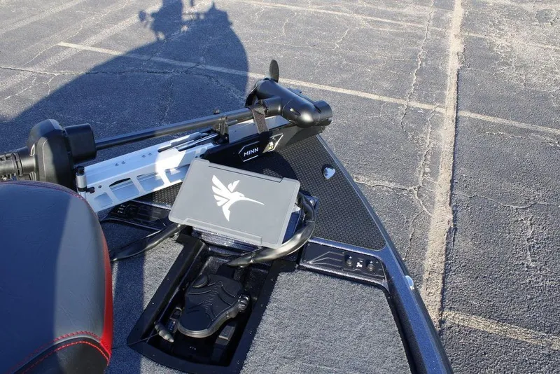 Slide: The Image of 2026 Phoenix 721 boat with Minn Kota trolling motor on asphalt surface. - 15
