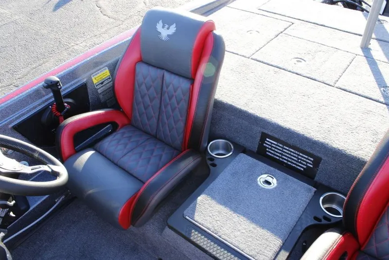 Slide: The Image of 2026 Phoenix 721 boat interior with red and gray seating, steering wheel, and cup holders. - 16