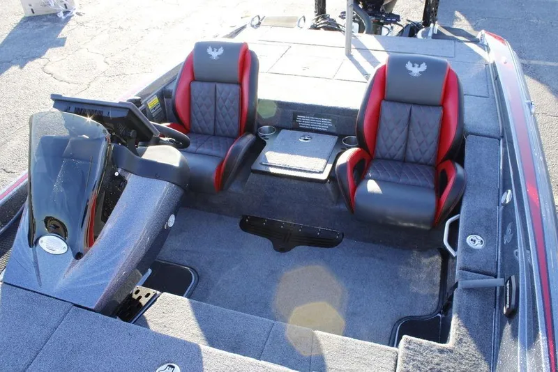 Slide: The Image of 2026 Phoenix 721 boat interior with dual red and black seats, steering console, and carpeted flooring. - 19