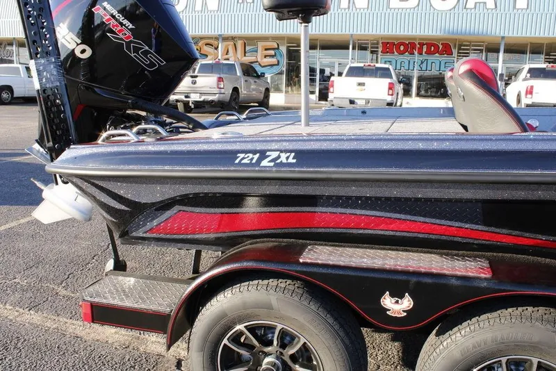Slide: The Image of 2026 Phoenix 721 boat with Mercury Pro XS engine, displayed outside a marine dealership. - 3