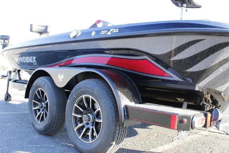 Slide: The Image of 2026 Phoenix 721 boat on trailer, featuring sleek design and dual wheels. - 4