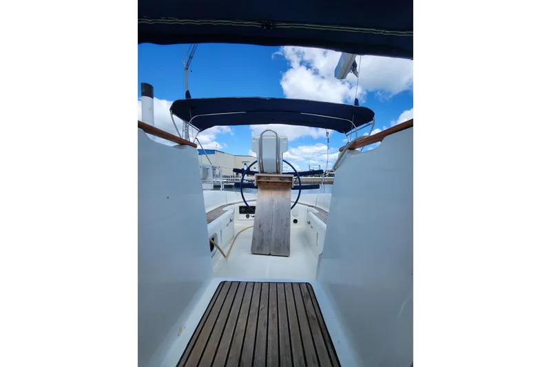 Slide: The Image of 2001 Jeanneau Sun Odyssey 34.2 sailboat cockpit with blue canopy and wooden deck. - 14