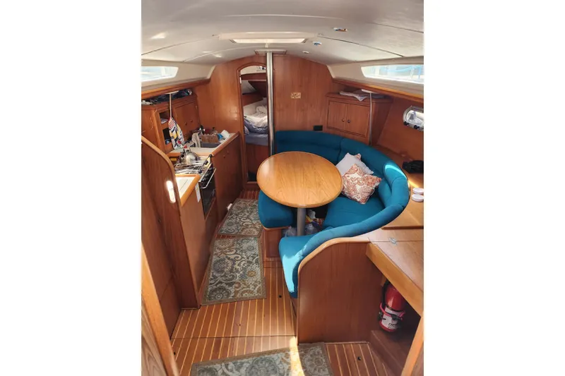 Slide: The Image of Interior of 2001 Jeanneau Sun Odyssey 34.2 sailboat with cozy seating and wooden finishes. - 15