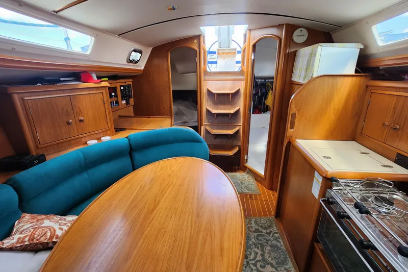 Slide: The Image of Interior of 2001 Jeanneau Sun Odyssey 34.2 sailboat with wood finish and cozy seating. - 16