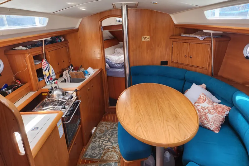 Slide: The Image of Interior of 2001 Jeanneau Sun Odyssey 34.2 sailboat with cozy seating and kitchen area. - 17