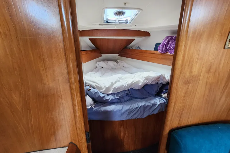 Slide: The Image of Cozy cabin interior of 2001 Jeanneau Sun Odyssey 34.2 sailboat with wooden finish. - 22