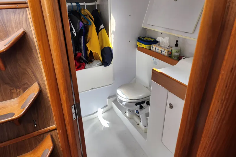 Slide: The Image of Interior of 2001 Jeanneau Sun Odyssey 34.2 yacht showing bathroom and storage area. - 25