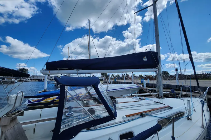 Slide: The Image of 2001 Jeanneau Sun Odyssey 34.2 sailboat docked under a blue sky with clouds. - 4