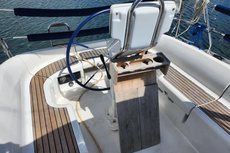 Slide: The Image of Cockpit of 2001 Jeanneau Sun Odyssey 34.2 sailboat with wooden seating and steering wheel. - 8