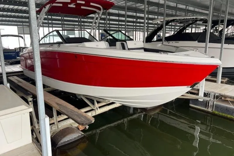 Slide: The Image of 2021 Cobalt R8 boat in red and white, docked in a covered marina. - 11