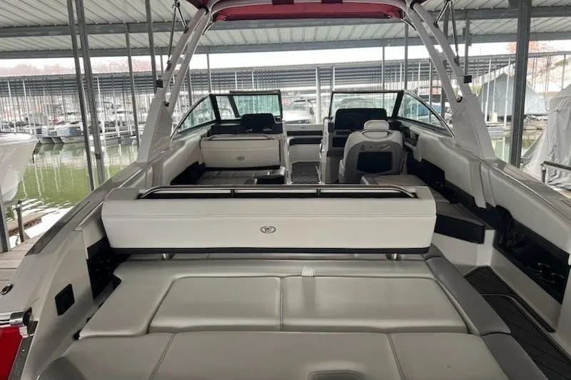Slide: The Image of 2021 Cobalt R8 boat interior with white seating, docked in a covered marina. - 14