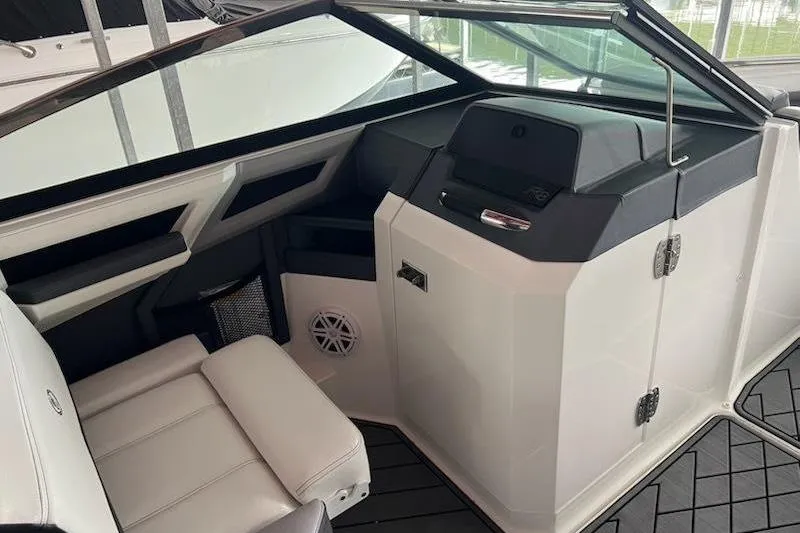 Slide: The Image of 2021 Cobalt R8 boat interior with sleek white seating and modern dashboard design. - 7