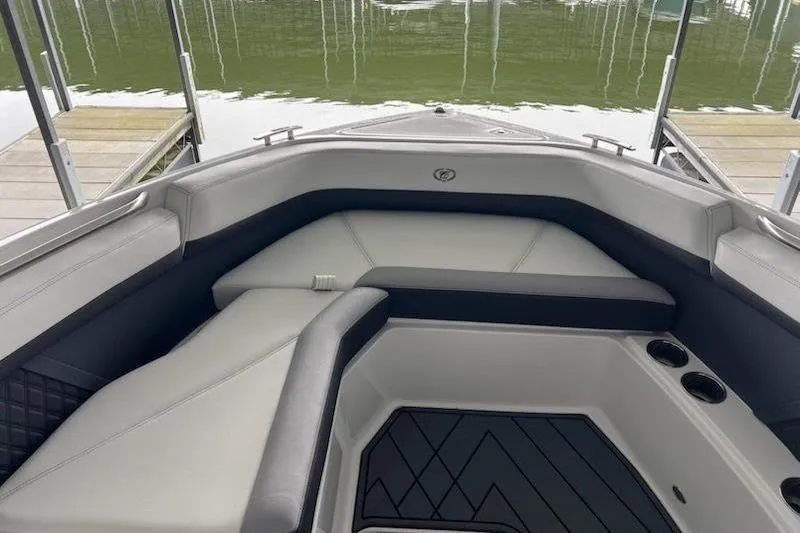 Slide: The Image of 2021 Cobalt R8 boat interior with cushioned seating and cup holders by the water. - 9