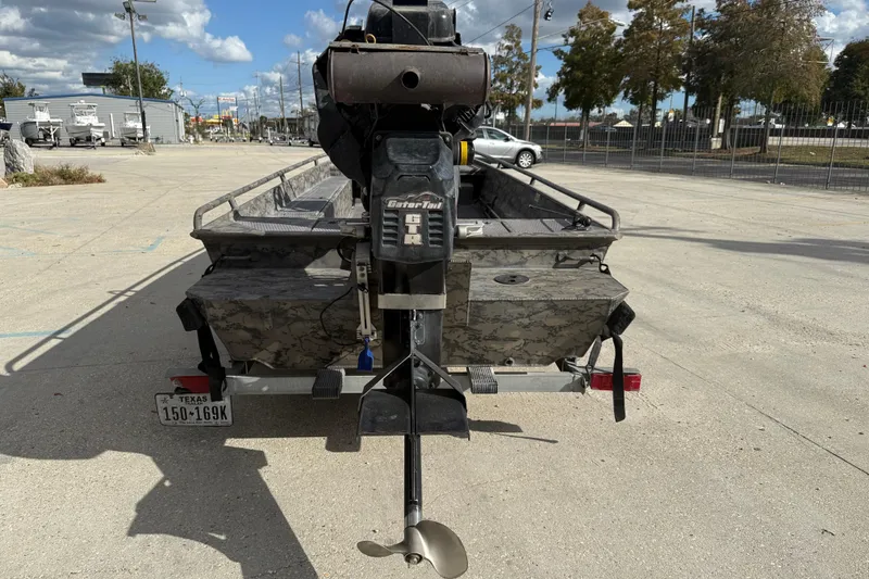 Slide: The Image of 2018 Gator Tail 1860cc Extreme boat with motor, parked outdoors on a sunny day. - 5