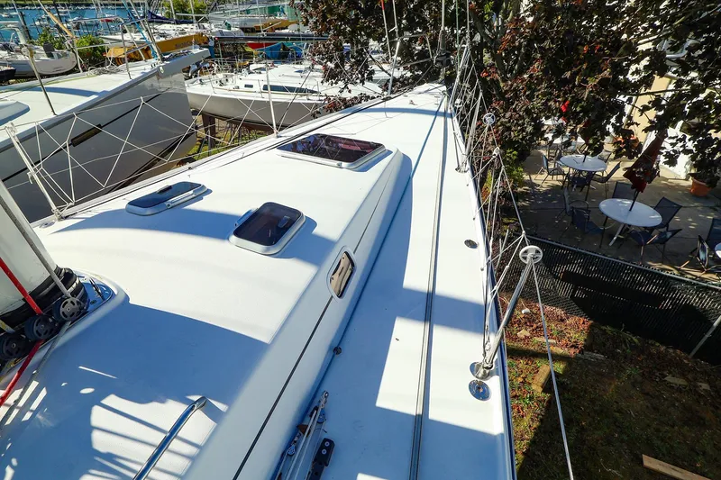 Slide: The Image of 2005 J Boats J/133 sailboat deck with hatches and rigging, docked in a marina. - 1
