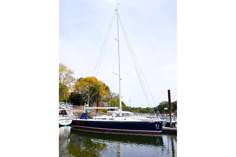 Slide: The Image of 2005 J Boats J/133 sailboat docked in a serene marina setting. - 16