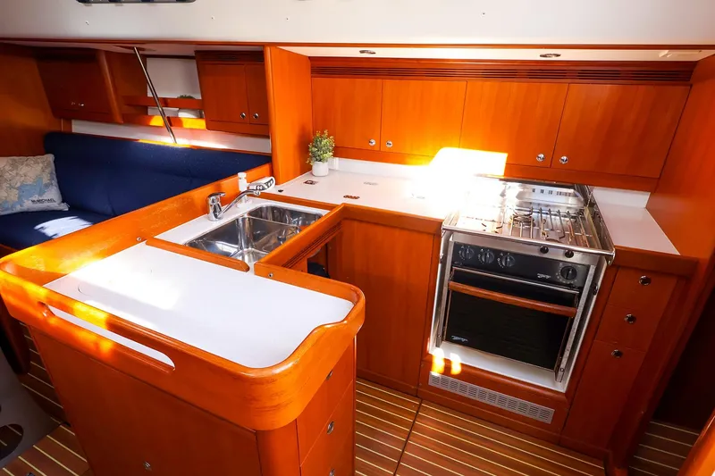 Slide: The Image of 2005 J Boats J/133 yacht interior with wooden cabinetry, stove, and sink. - 20