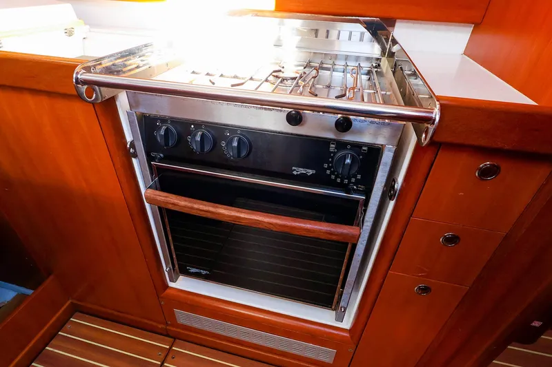 Slide: The Image of 2005 J Boats J/133 yacht kitchen with stainless steel oven and wooden cabinetry. - 21