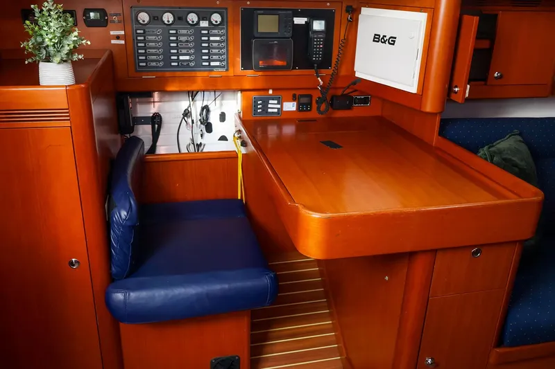 Slide: The Image of Navigation station of 2005 J Boats J/133 yacht with control panels and seating. - 26