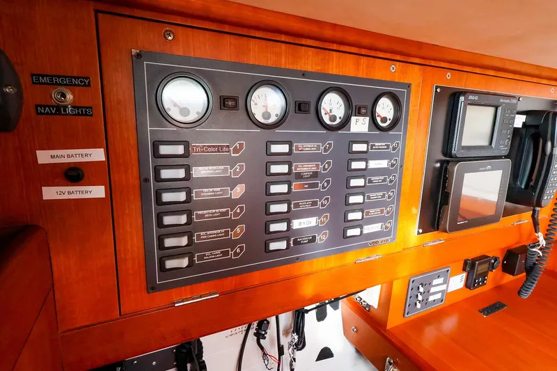 Slide: The Image of Electrical control panel on a 2005 J Boats J/133 sailboat, featuring gauges and navigation equipment. - 27