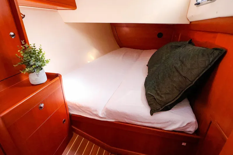 Slide: The Image of Cozy cabin interior of 2005 J Boats J/133 with bed and wooden cabinetry. - 32