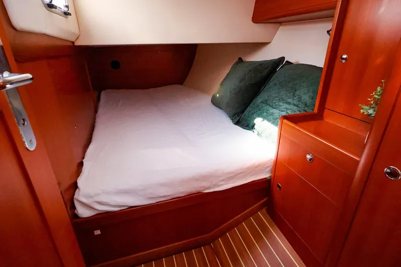 Slide: The Image of Cozy cabin interior of 2005 J Boats J/133 with wooden finish and comfortable bedding. - 33