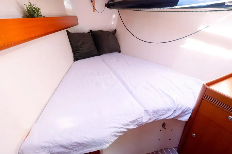 Slide: The Image of Cozy cabin interior of 2005 J Boats J/133 with bed and wooden accents. - 34