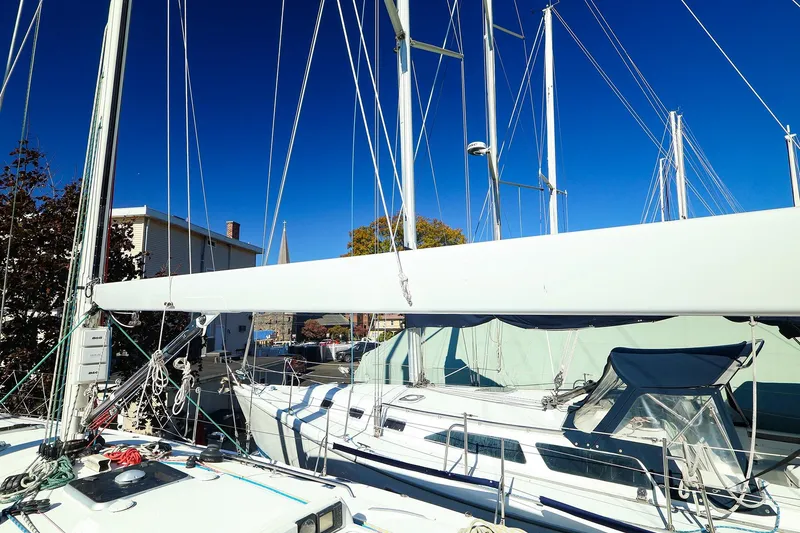 Slide: The Image of 2005 J Boats J/133 sailboat with mast and rigging under clear blue sky. - 4