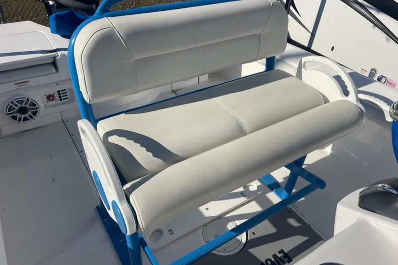 Slide: The Image of 2021 Everglades 243 Center Console boat seat with blue accents and white upholstery. - 11