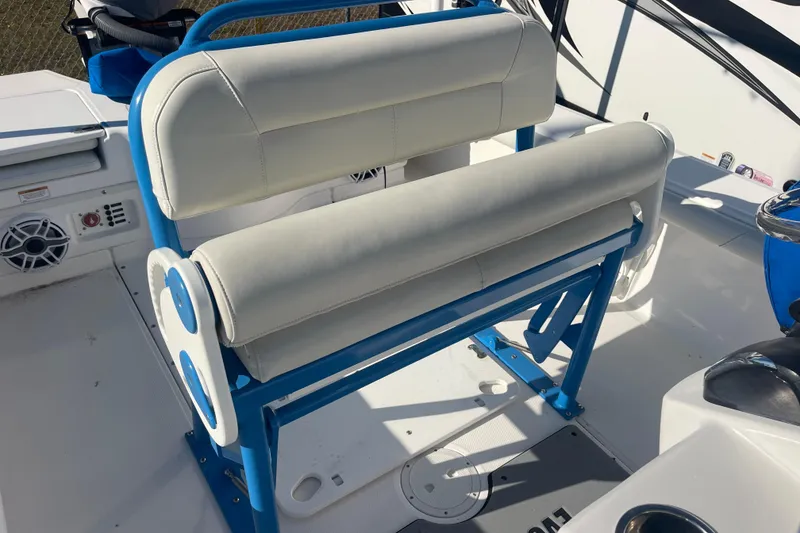 Slide: The Image of 2021 Everglades 243 Center Console boat with white and blue seating. - 12