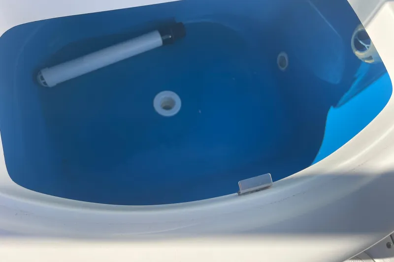 Slide: The Image of Livewell in 2021 Everglades 243 Center Console boat, featuring blue interior. - 15