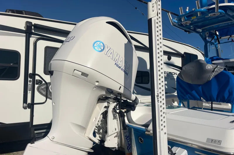 Slide: The Image of 2021 Everglades 243 Center Console with Yamaha outboard motor, parked near RV. - 25