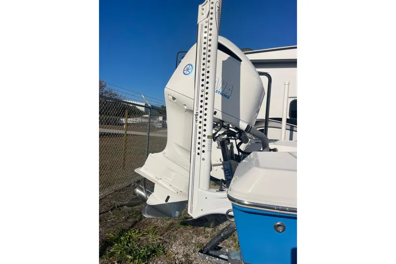 Slide: The Image of 2021 Everglades 243 Center Console boat with Yamaha outboard motor, parked outdoors. - 26