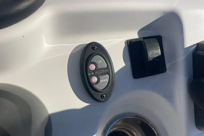 Slide: The Image of Control panel on 2021 Everglades 243 Center Console boat, featuring up and down buttons. - 28