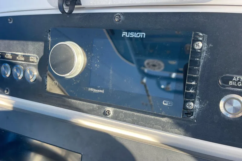 Slide: The Image of Control panel of 2021 Everglades 243 Center Console boat with Fusion audio system. - 3