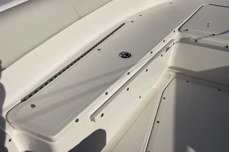 Slide: The Image of 2021 Everglades 243 Center Console boat deck with storage compartments. - 32