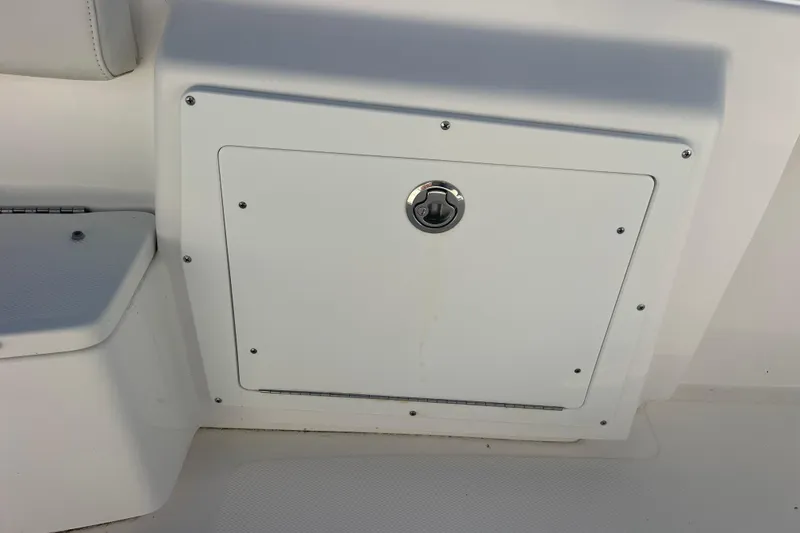 Slide: The Image of 2021 Everglades 243 Center Console boat storage compartment with secure latch. - 34