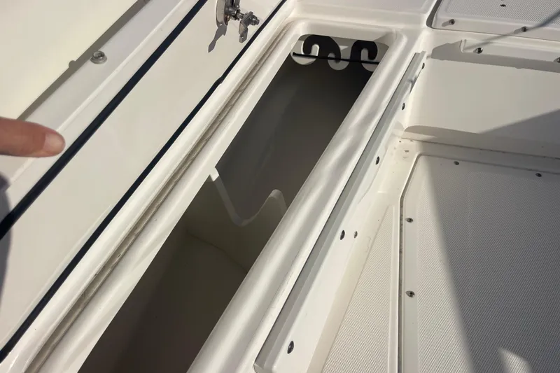 Slide: The Image of Open storage compartment on 2021 Everglades 243 Center Console boat. - 36