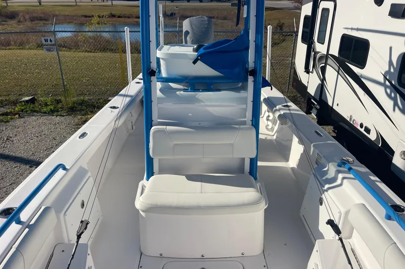 Slide: The Image of 2021 Everglades 243 Center Console boat interior with seating and fishing rod holders. - 43