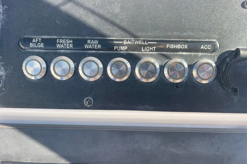 Slide: The Image of Control panel of 2021 Everglades 243 Center Console boat with labeled buttons. - 5