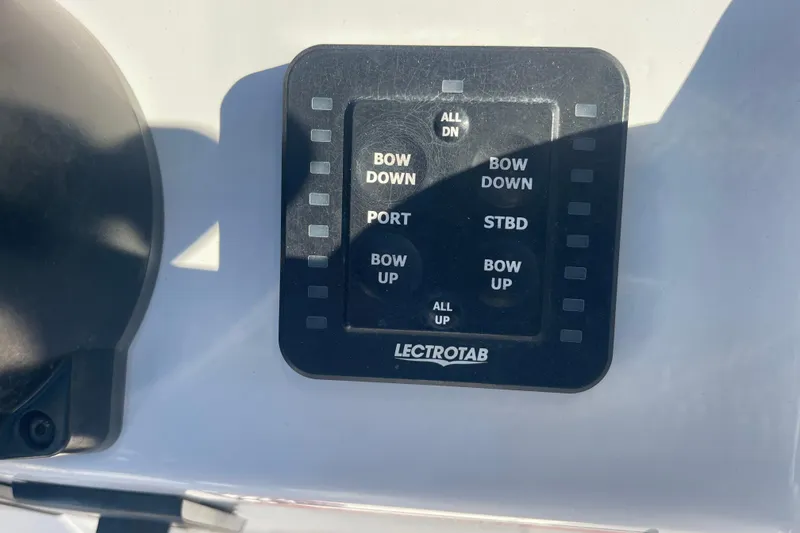 Slide: The Image of Control panel of a 2021 Everglades 243 Center Console boat with Lectrotab trim tab switches. - 7