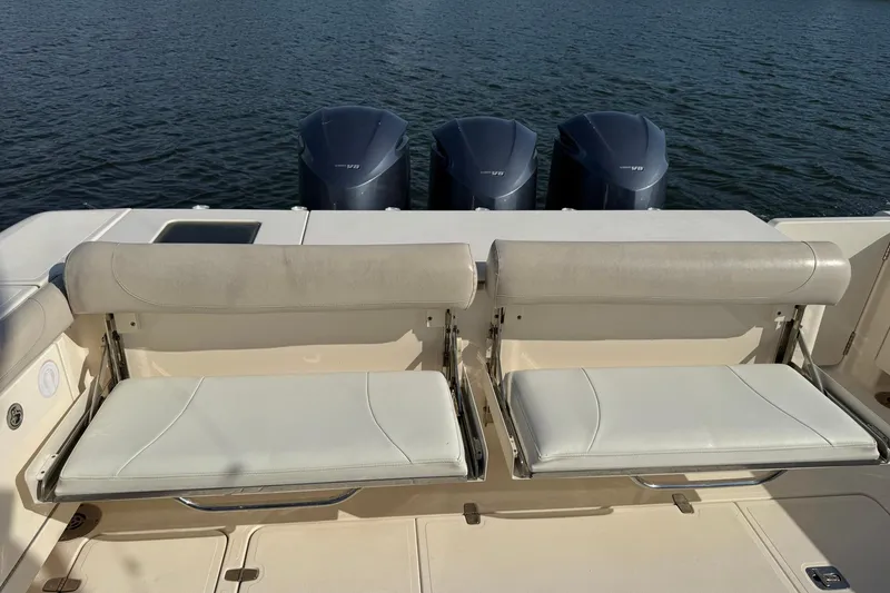 Slide: The Image of 2011 Pursuit OS 375 Offshore boat with dual seats and triple outboard engines. - 11