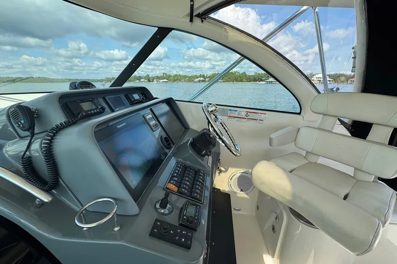 Slide: The Image of 2011 Pursuit OS 375 Offshore helm with navigation equipment and comfortable seating. - 25