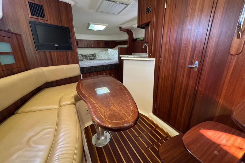 Slide: The Image of Luxurious interior of 2011 Pursuit OS 375 Offshore boat with wood finishes and seating area. - 27