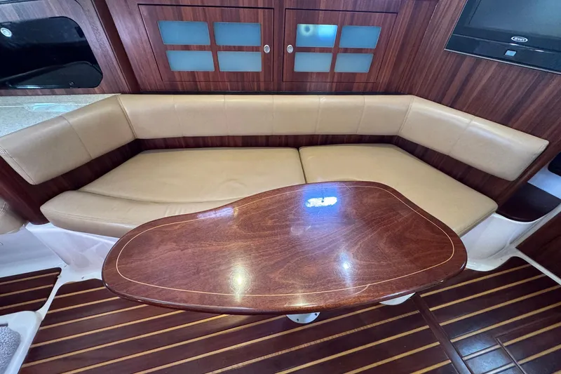 Slide: The Image of Luxurious interior of 2011 Pursuit OS 375 Offshore with leather seating and wooden table. - 32