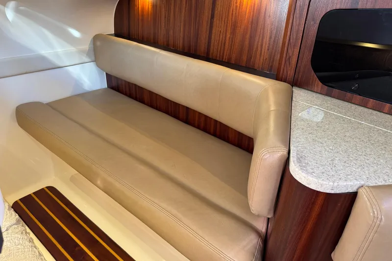 Slide: The Image of Luxurious interior of 2011 Pursuit OS 375 Offshore boat with beige seating and wood accents. - 34