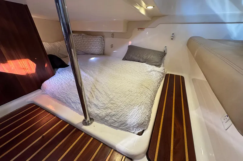 Slide: The Image of Cozy cabin interior of 2011 Pursuit OS 375 Offshore with comfortable bedding. - 35