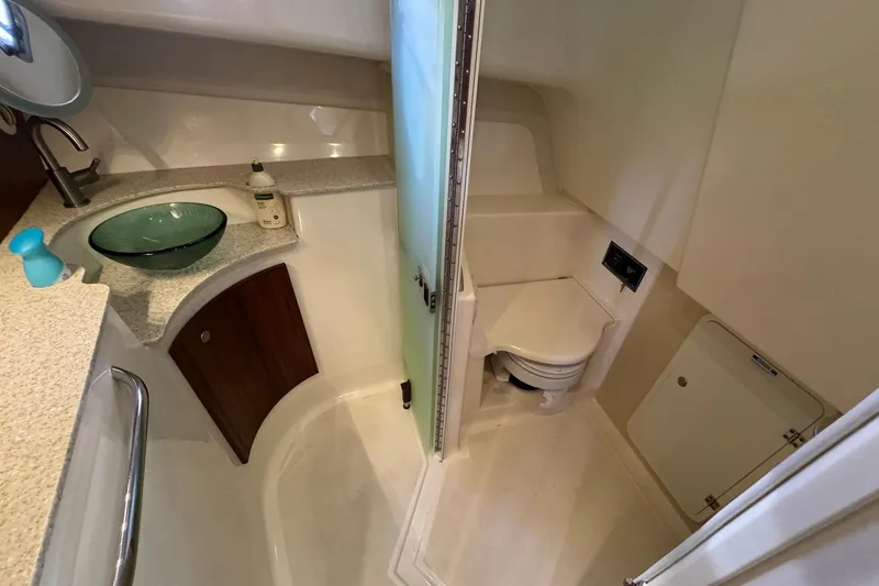 Slide: The Image of 2011 Pursuit OS 375 Offshore boat bathroom with sink, toilet, and storage. - 36