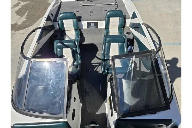 Slide: The Image of 1997 Javelin 389 FS boat interior with dual green and white seats, open windshield. - 10